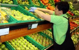Una treballadora d'un supermercat de Lleida col·locant fruita . ACN