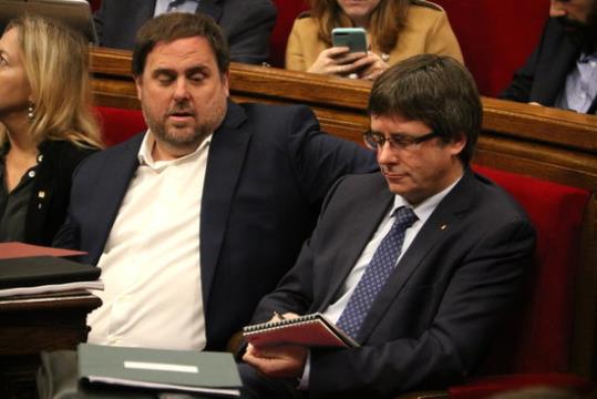 Carles Puigdemont, pren nota sota la mirada del vicepresident Oriol Junqueras. ACN / Núria Julià