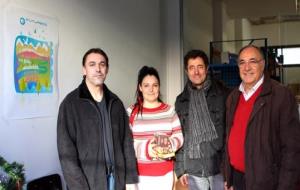 EIX. Una família usuària del Rebost Solidari rebent els lots amb Rafael Juncosa i Manuel Medina