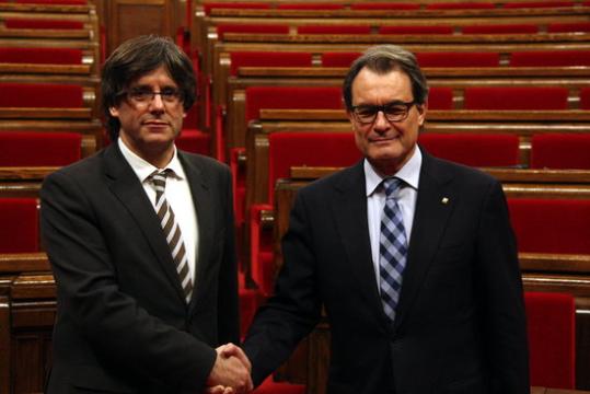 Encaixada de mans entre Artur Mas i Carles Puigdemont un cop finalitzat el ple d'investidura. ACN