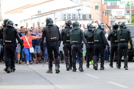 Agents de la Guàrdia Civil replegant-se perseguits per desenes de ciutadans a Móra la Nova. ACN / Anna Ferràs