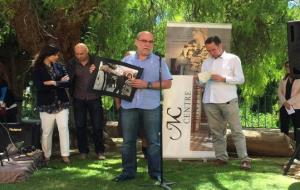 El portaveu del jurat dels Molero, Lluís Gené, mostra la fotografia guanyadora dels Molero, de Carles Castro. EIX