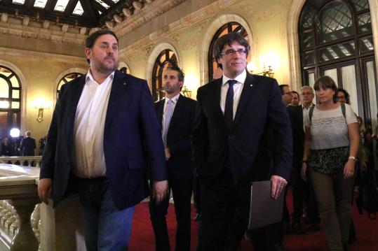 El president de la Generalitat, Carles Puigdemont, i el vicepresident del Govern, Oriol Junqueras, dirigint-se a l'hemicicle. ACN