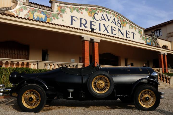 Pla general de la façana principal de les caves Freixenet, a Sant Sadurní d'Anoia, amb un vehicle amb forma d'ampolla en primer terme. ACN