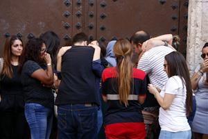 Pla mitjà de familiars i amics de la noia morta al Port Olímpic de Barcelona, abraçant-se durant l'acte d'homenatge que s'ha fet a la plaça Vella del 