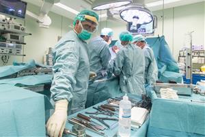 Pla obert d'un quiròfan de l'hospital de Palamós amb diversos metges operant un pacient en una imatge d'arxiu. SSIBE
