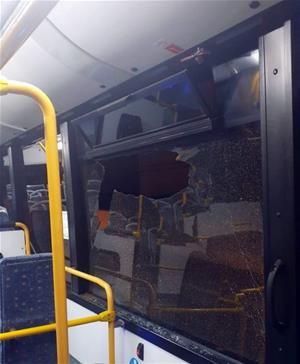 Pla obert d'una finestra de l'autobús urbà de Calafell (Baix Penedès), trencada pel llançament d'una pedra. Policia local de Calafell