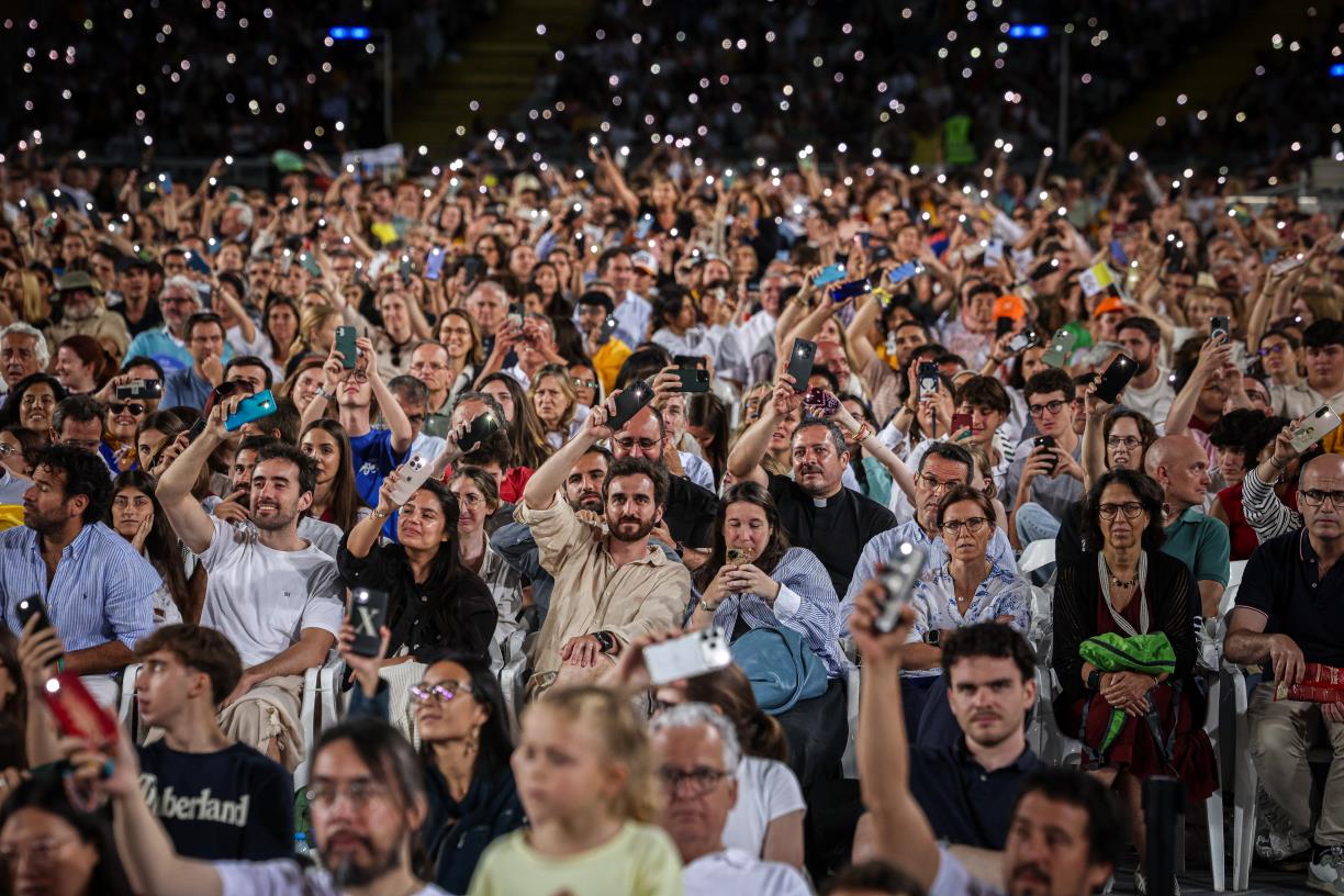 Fidels aixecant les llanternes del mòbil en la part final de la vetlla del papa Lleó XIV a l'Estadi Olímpic . ACN / Jordi Borràs