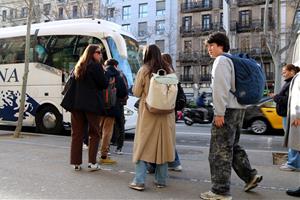 Usuaris agafant un bus e15 cap a Vilanova i la Geltrú a la Gran Via de Barcelona 